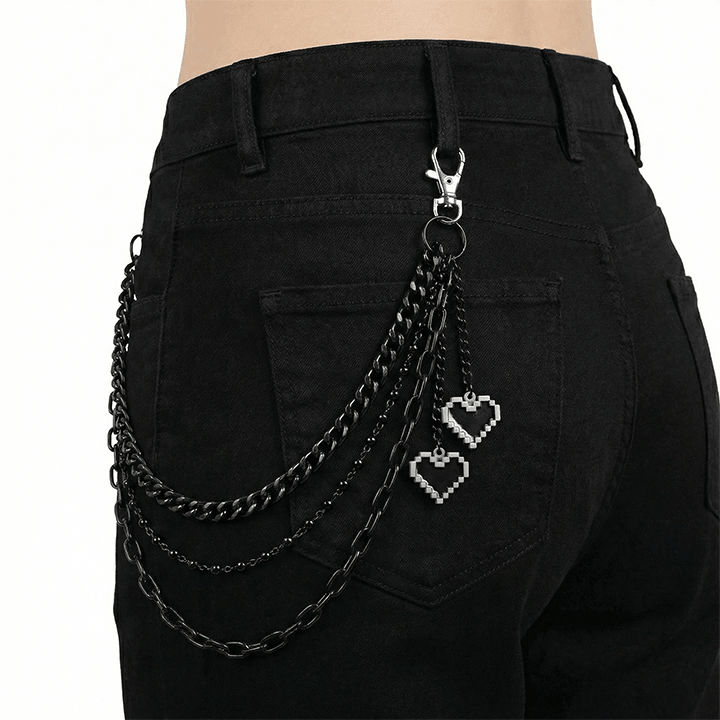 Black layered heart wallet chain with pixel charms attached to black jeans