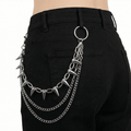 Silver spike wallet chain layered on black jeans