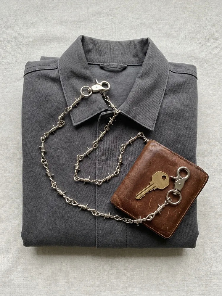 Barbed wire wallet chain flat lay with wallet and key