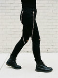 Barbed wire jeans chain swinging while walking
