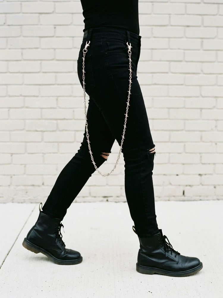 Barbed wire jeans chain swinging while walking