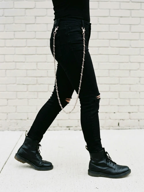 Barbed wire jeans chain swinging while walking