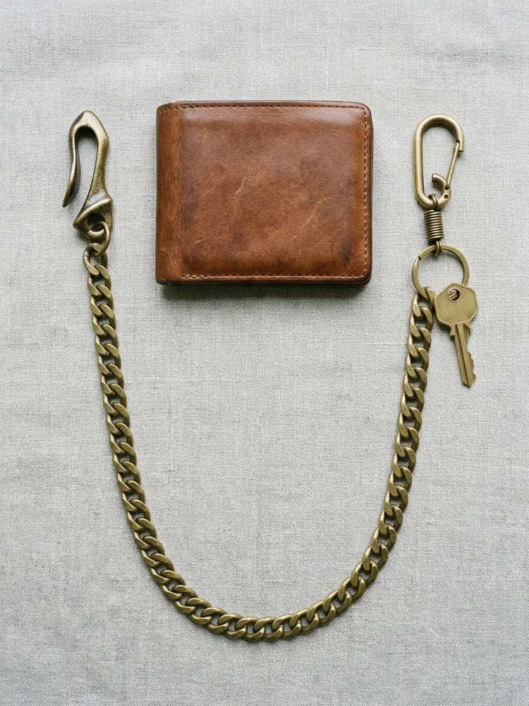 Cuban wallet chain flat lay with leather wallet and key