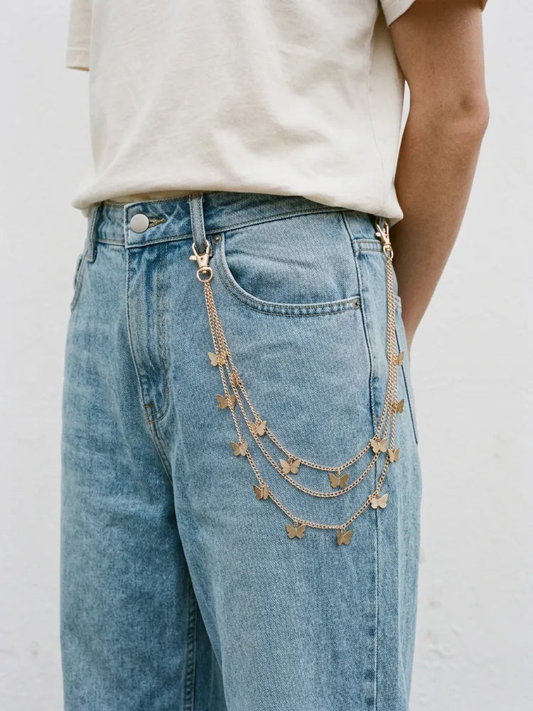 Gold butterfly pants chain worn on light jeans