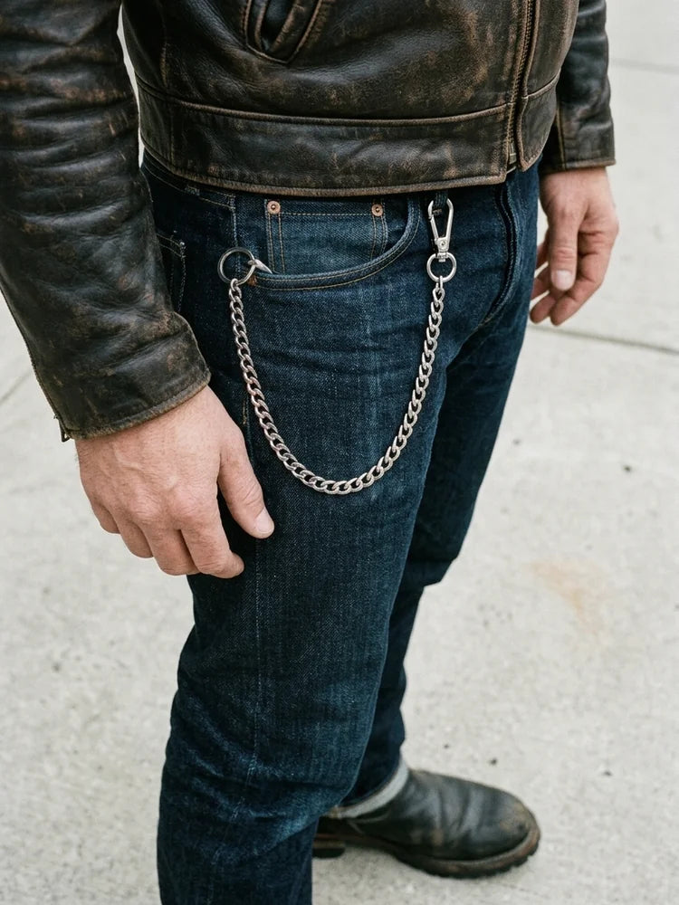 Silver curb wallet chain worn on raw denim