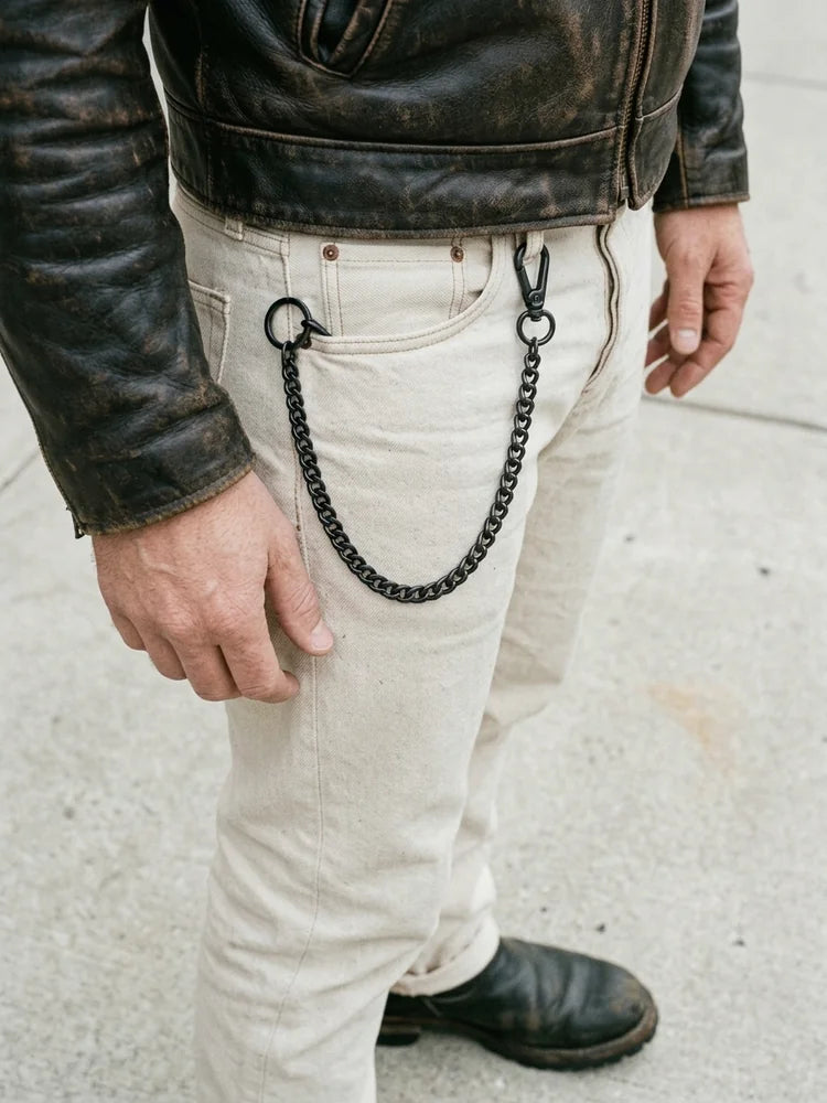 Black curb wallet chain worn on ecru denim