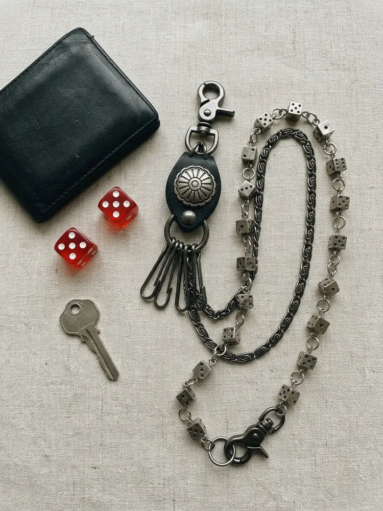 Dice wallet chain flat lay with wallet and red dice