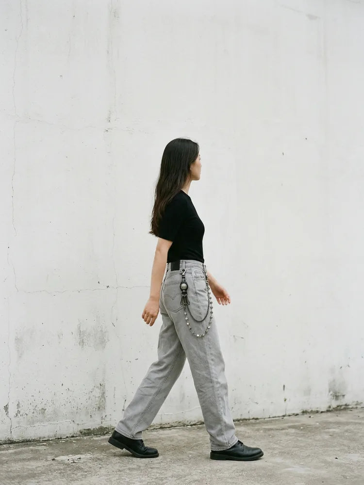Grey jeans outfit with dice pants chain, women