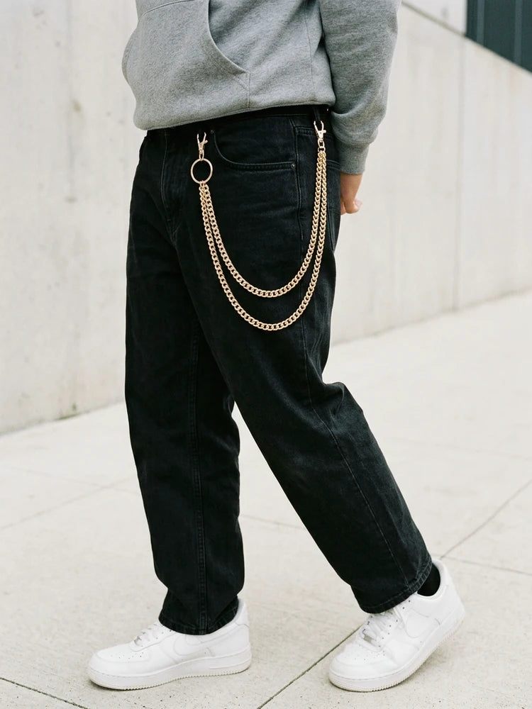 Gold layered jeans chain while walking