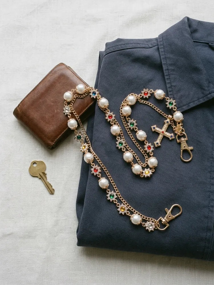 Pearl cross chain flat lay with wallet and key