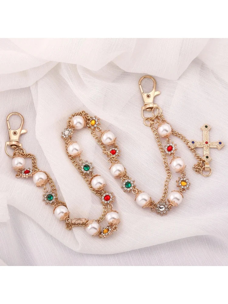 Pearl pants chain with cross in gold tone