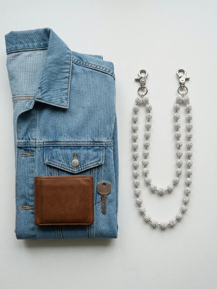 Rhinestone chain flat lay with wallet and key