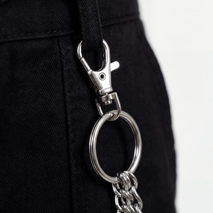 Close up of silver triple pants chain lobster clasp and ring detail